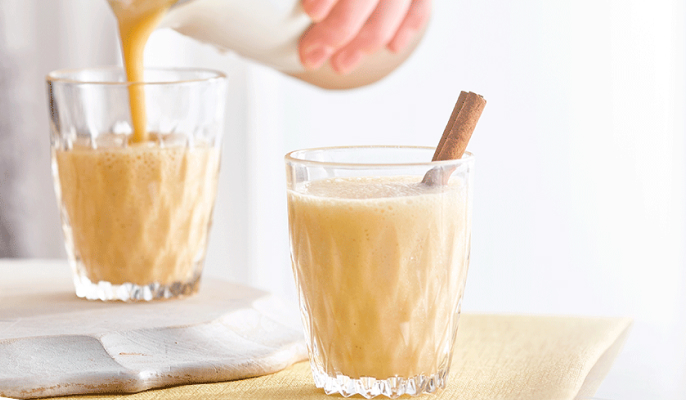 Peach smoothie recipe made with Vanilla Ensure® Regular being poured
